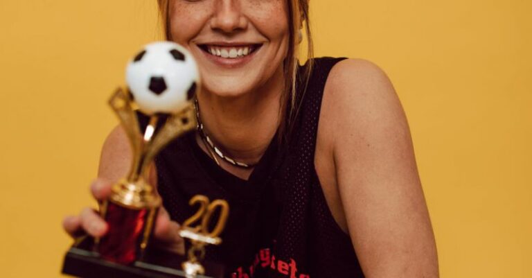 Recognition And Reward - A Smiling Woman Holding a Trophy