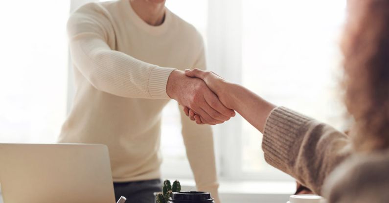 Team Meetings - Man and Woman Near Table