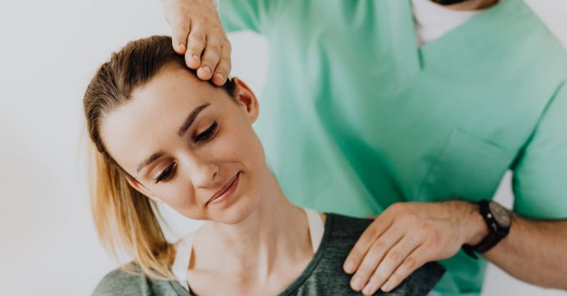 Strain Injuries - Professional Massage Therapist Treating a Female Patient's Injured Neck